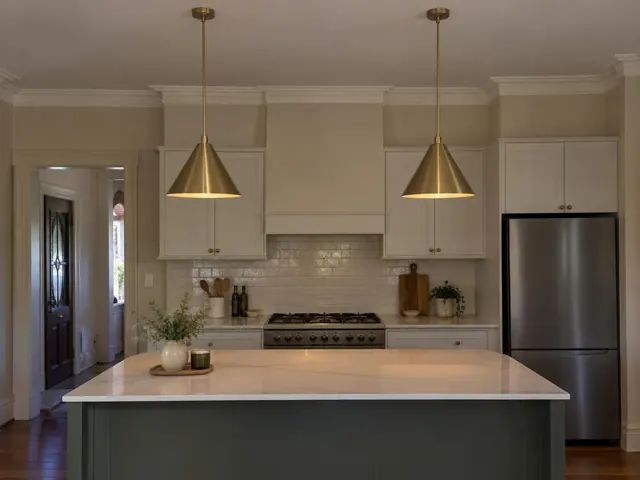 Two brass pendant lights above a kitchen island in a modern cream kitchen in Broadmeadow